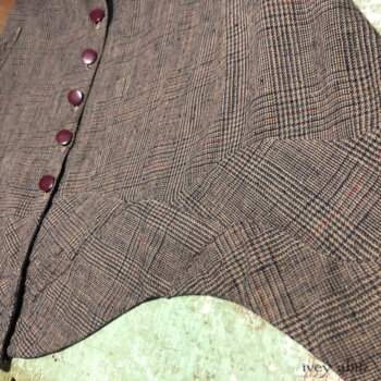Bottom hem detail of a Grasmere Vest in a plaid weave.