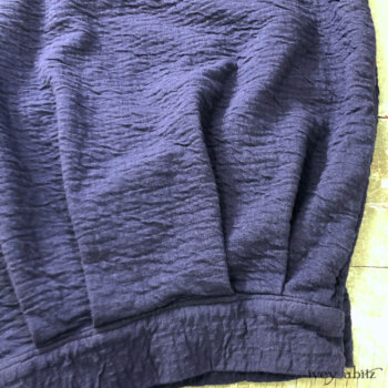 Bottom hem detail of our clever and fun to wear Coulson Trousers. Chosen here in a crinkled knit.