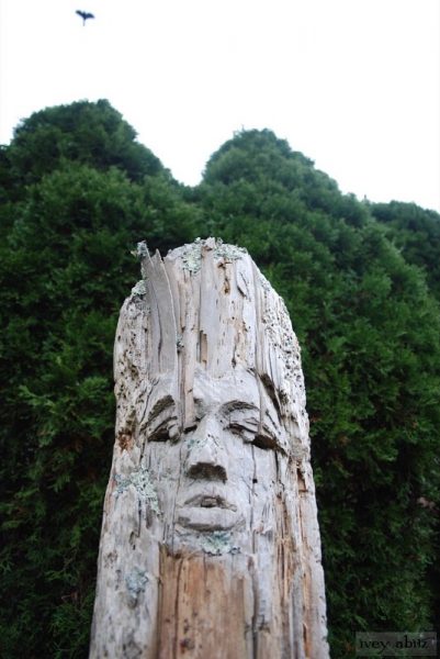 A bird of prey soars over a carving in the garden at Saturday Farm.