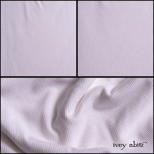 Description: We have heard from our beloved clients how much you are enjoying our new ribbed knits. Here is a new version, this time in our Sailcloth hue (classic white). It is ideal for a selection of slip frocks, camisoles, and cardigans. Please note: this fabric has a significant give to it. Even though it will be cut in the size you choose, it will have a give up to a least a size larger. This is the nature of the knit which gives it its extraordinary drape and comfort. You can order a size down from your normal sizing, and it will still drape well.We have put it through an additional washing process to enhance the softness. Opaque and very breathable, it is a good choice for layering in cooler seasons or on its own in warmer temperatures for the hottest summer days. Content: All natural viscose. Woven in the United States. All season weave.Care: Simply hand wash or put through machine delicate cycle in cold water with a plant based detergent. We suggest using a natural fabric softener to maintain the softness we have washed into it. Tumble dry on extra-low heat with our artisan wool dryer balls to keep the relaxed effect that is featured in the Look Book. If you are the least bit concerned about any fabric weight or hue, order the fabric swatch portfolio so you can have them in hand whilst you decide. They will answer all of your questions!
