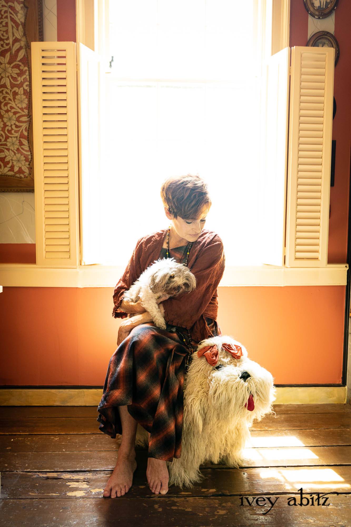 Montmorency Wrap Jacket in Copper Embroidered Voile; Meriwether Frock in Copper Softest Plaid Twill; Cilla Slip Frock in Signature Black Washed Silk Jersey Knit; Nouvelle Necklace. - Bespoke clothing by Ivey Abitz. Featuring Carolyn Hennesy with rescue dogs and cats.