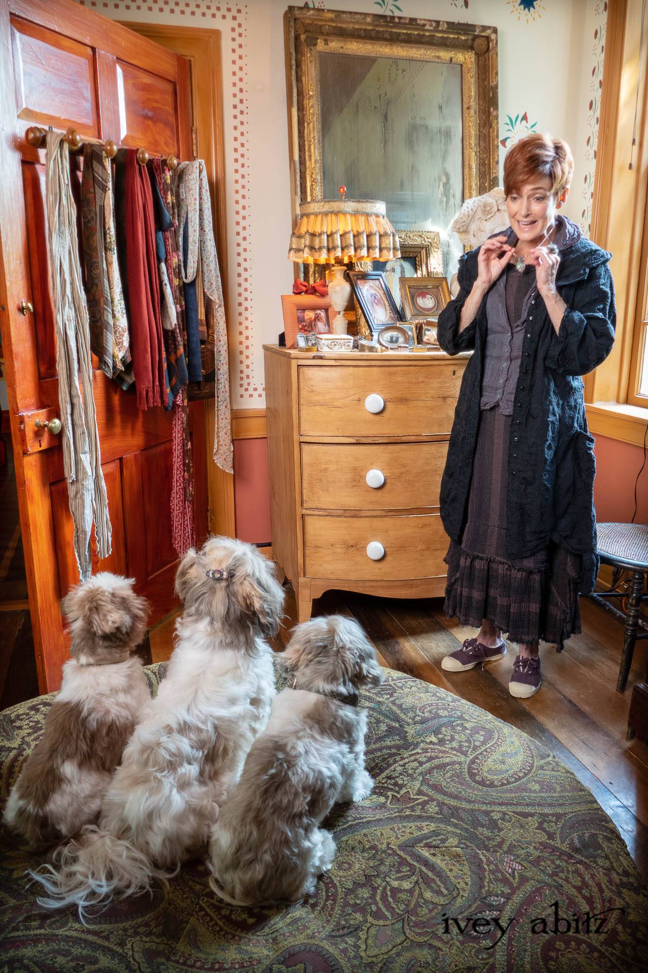 Celia Duster Coat in Black Diamond Embroidered Leaf Weave; Sollie Shirt in Amethyst and Pewter Washed Voile; Celia Skirt in Amethyst Washed Flannel Backed Plaid; Cilla Slip Frock in Signature Black Washed Silk Jersey Knit; Bonheur Brooch in Sculpted Felt. - Bespoke clothing by Ivey Abitz. Featuring Carolyn Hennesy with rescue dogs and cats.