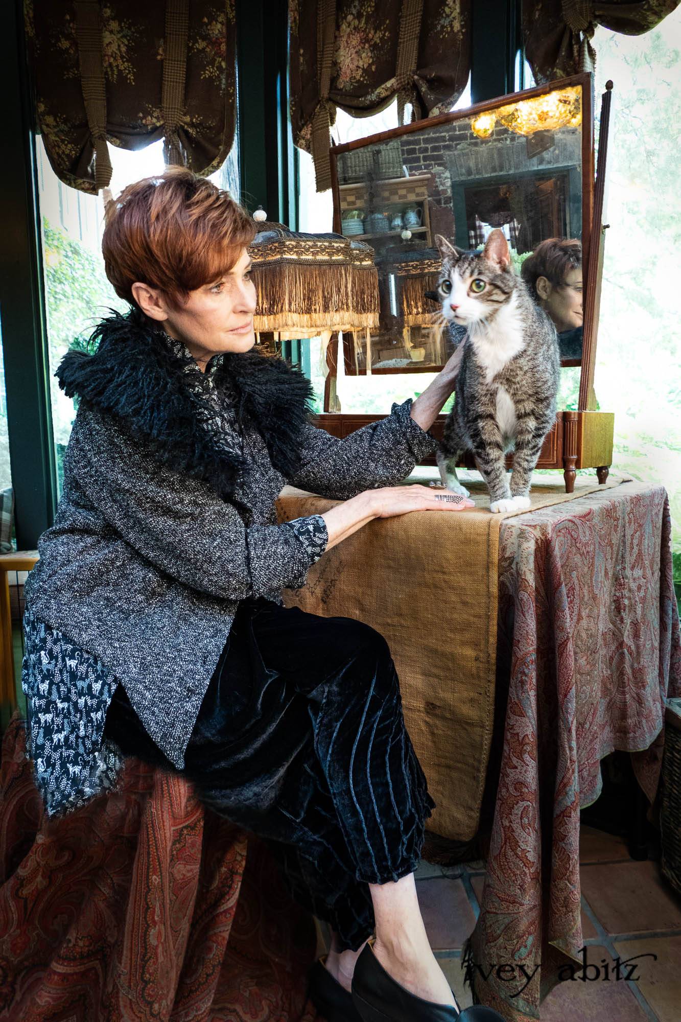 Coulson Cardigan in Black Diamond Nubby Knit; Pemberley Shirt Black Diamond Cool Cat Weave; Nouvelle Necklace; Lydia Trousers in Black Diamond Silk Velvet. - Bespoke clothing by Ivey Abitz. Featuring Carolyn Hennesy with rescue dogs and cats.